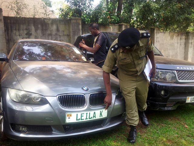 A police officer inspects Kayondo;s car at Interpol headquarters 